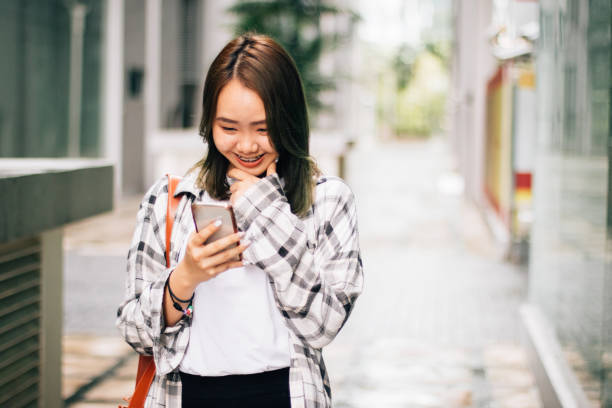 istock Smiling Asian Corporate Female Checking Smartphone Messages 1179607833