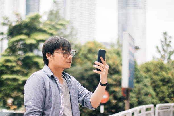 istock Young Asian Man Using Smart Phone to Make Video Call via Internet 1179608024