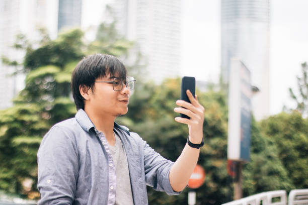istock Young Asian Man Using Smart Phone to Make Video Call via Internet 1179608052