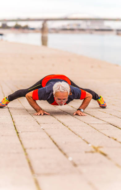 istock Senior man doing push-ups outdoors 1179609249