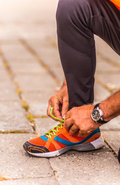 istock Senior man shoestring outdoors 1179610361