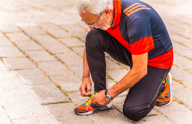istock Senior man shoestring outdoors 1179610411