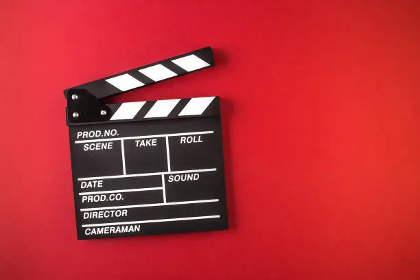 clapperboard, red background
