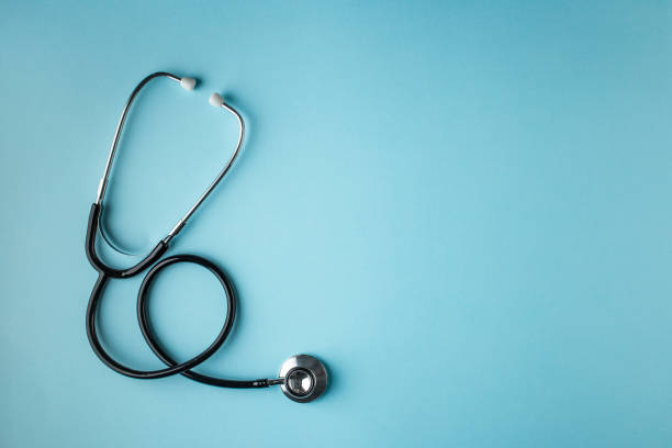 Black stethoscope on blue background stethoscope, black, blue background, isolated medical instrument stock pictures, royalty-free photos & images