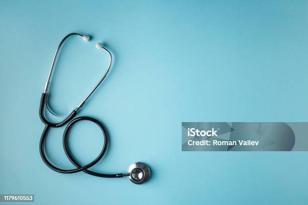 Black Stethoscope On Blue Background Stock Photo - Download Image Now - Healthcare And Medicine, Stethoscope, Doctor