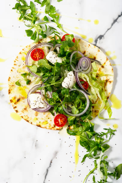 istock Unwrapped tortilla with fresh salad and roasted chicken. 1179610577