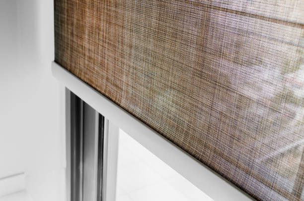 istock Closeup brown color Roller blinds curtains. sunlight through the windows in the city. Selective focus image. 1179611281