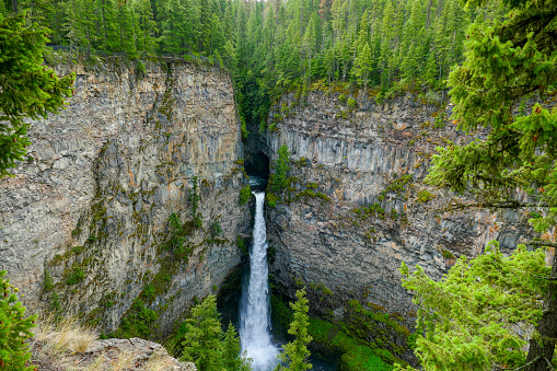Spahats Creek Falls, or Spahats Falls, is located within Wells Gray Provincial Park, British Columbia, Canada. Spahats Creek, from which the Falls gets its name, flows through a cave-like formation before tumbling through a keyhole slot into a narrow and deep canyon below.