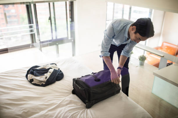 istock Businessman zipping up suitcase and getting ready for a trip 1179613039