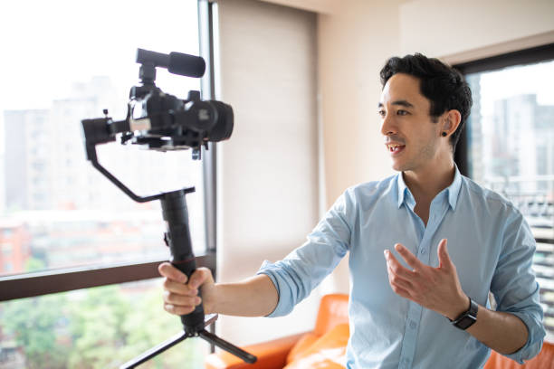 istock Mixed race man recording vlog in apartment 1179613285
