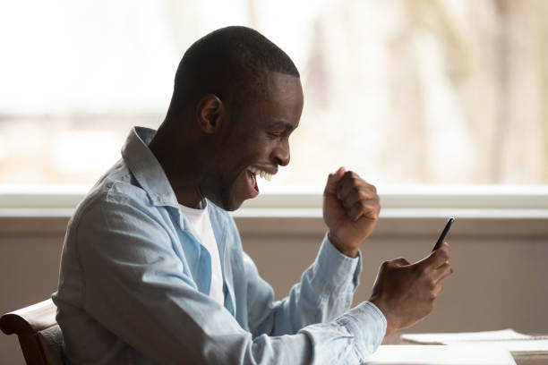 istock Excited lucky mixed race young man received win sms notification. 1179614177