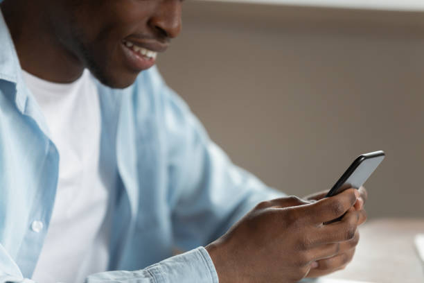 istock Cropped image happy smiling african american man surfing internet. 1179614182