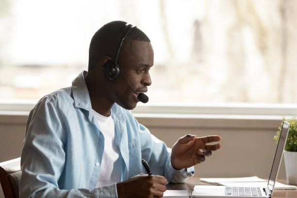 istock Happy focused african ethnic young guy attending online educational seminar. 1179614190
