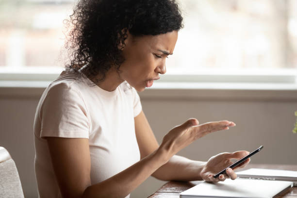 istock Angry african american young woman irritated by broken device. 1179614268