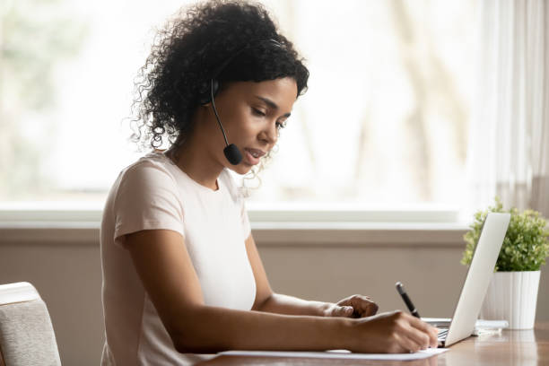istock Focused african ethnicity lady watching educational online lecture webinar. 1179614276
