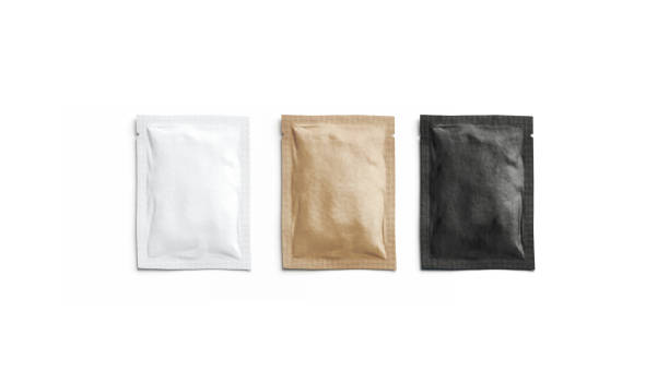 Blank black, white and craft paper sachet packet mockup, isolated Blank black, white and craft paper sachet packet mockup, isolated, 3d rendering. Empty kraft coffee packaging mock up, top view. Clear sealed wrapper for salt or pepper mokcup template. airtight photos stock pictures, royalty-free photos & images