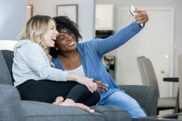 istock Friends taking selfie on couch in new apartment 1179617308