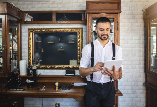istock Barber surfing the internet during his break 1179617763