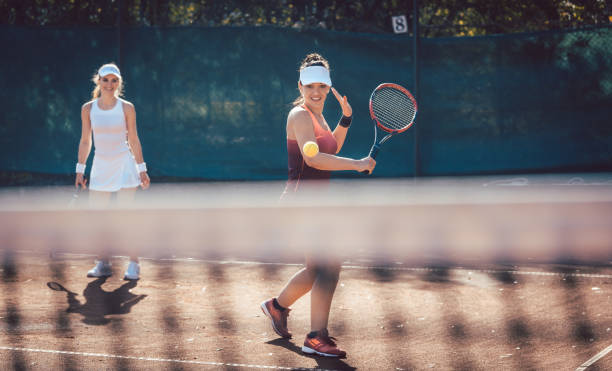 istock Woman in a tennis double 1179619251