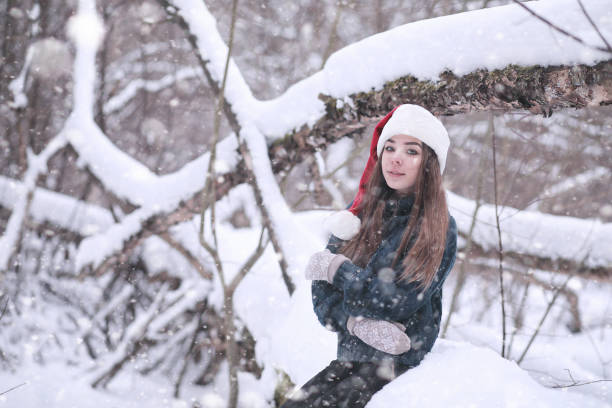 istock Girl in a winter park in snowfall 1179621580