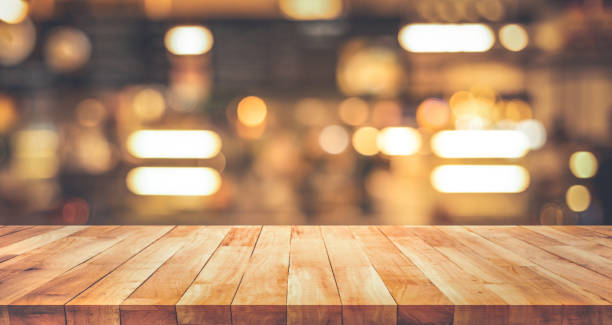istock Wood texture table top (counter bar) with blur light gold bokeh in cafe,restaurant background 1179621653