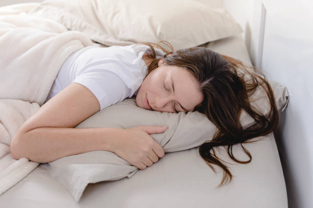 istock Beautiful woman sleeping face down on her bed 1179621841