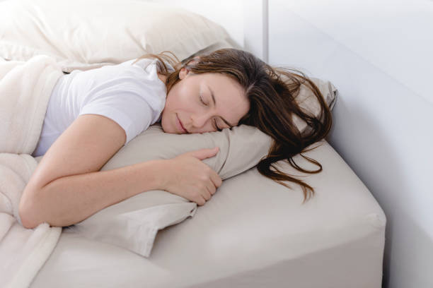 istock Beautiful woman sleeping face down on her bed 1179621891