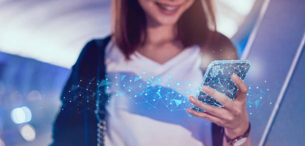 istock technology networking concept, woman holding abstract polygonal wireframe smartphone and searching for digital innovative. 1179622670