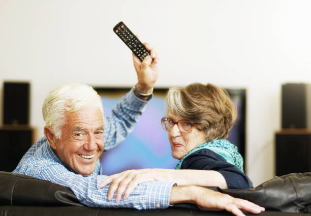 istock Husband waves remote as he wins control of senior couple's TV viewing 1179623883