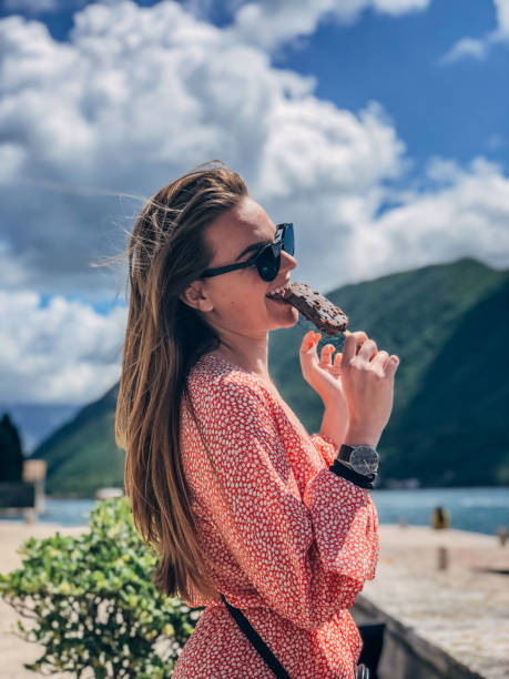 istock Pretty woman eating ice cream 1179623921