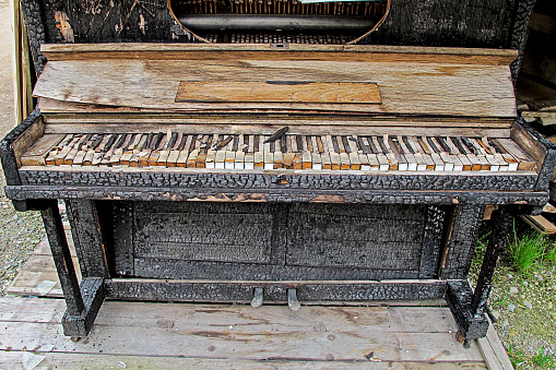 old, in a fire, charred burned piano