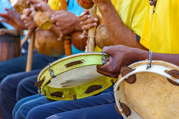Tambourine, berimbau and others instruments player during presentation of Brazilian capoeira Brazilian musical instrument called berimbau, Tambourine and others usually used during capoeira brought from africa and modified by the slaves latin music photos stock pictures, royalty-free photos & images