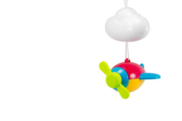 children's toy children's toy hanging airplane multicolored with a cloud isolated on a white background hanging mobile stock pictures, royalty-free photos & images