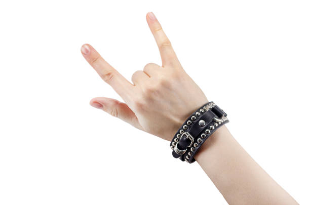 leather rocker bracelet hand with leather rocker bracelet with rock and roll sign, rock music isolated on white background rocker nails stock pictures, royalty-free photos & images