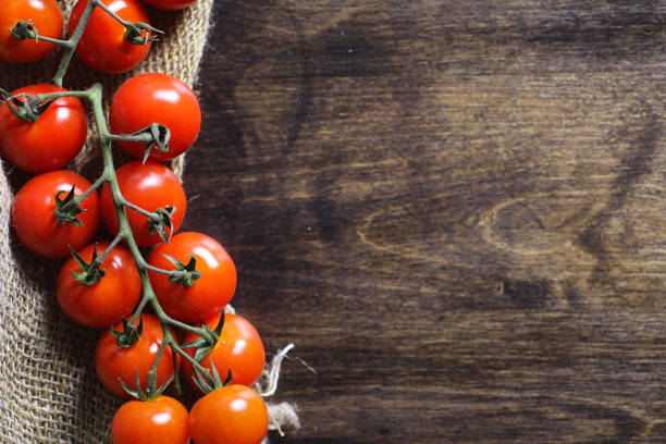 istock Branch with fresh cherry tomatoes. Ripe red tomatoes. Tomatoes and pasta with spices. 1179629343