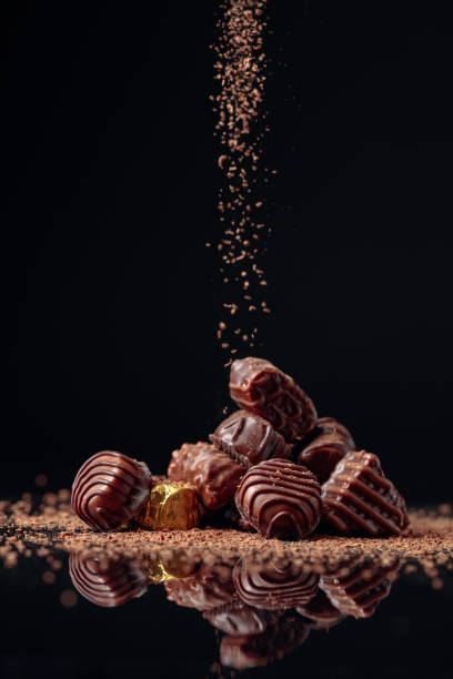 istock Chocolate candies on a black background sprinkled with chocolate chips. 1179630550