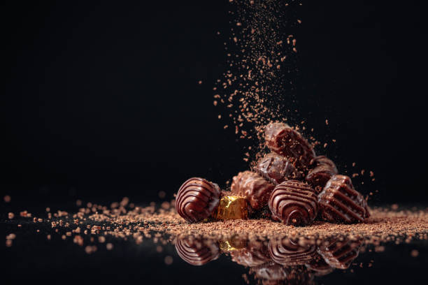 istock Chocolate candies on a black background sprinkled with chocolate chips. 1179630567