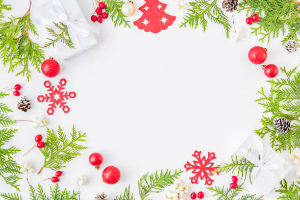 istock Flat lay frame with evergreen tree branch, christmas decorations and gift box on a white background 1179631636