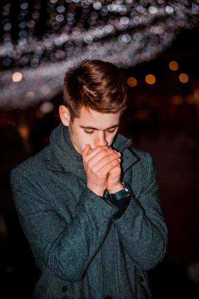 istock Man trying to warm up his hands at winter night 1179631847