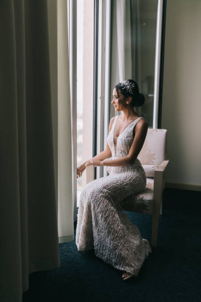 istock Beautiful young bride posing in hotel apartment on wedding day 1179633037