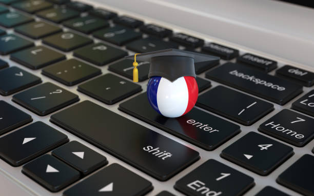 istock French flag with graduation cap on laptop keyboard 1179633429