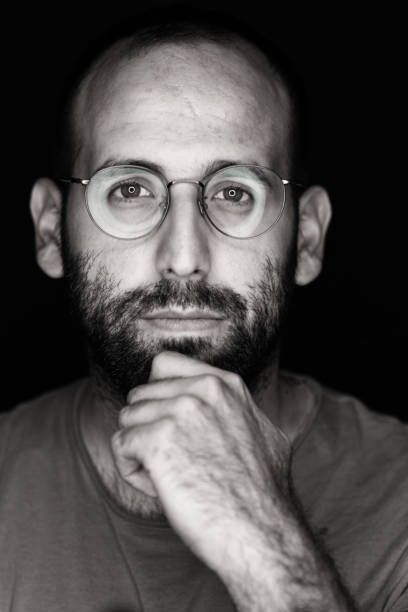 istock Thoughtful spectacles guy stock photo 1179634295