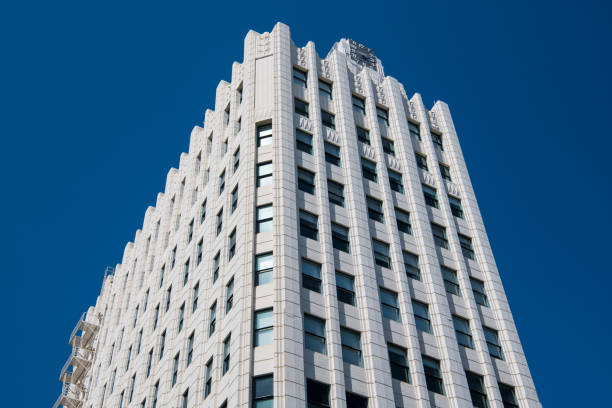 istock Horizontal view of a beautiful art deco style skyscraper clad in white stone with a clock on top 1179634379