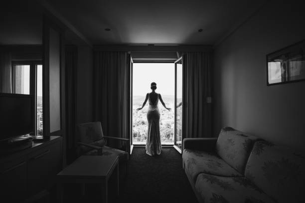 Beautiful young bride posing in hotel apartment on wedding day