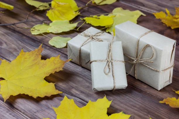 istock gift boxes among autumn leaves on a wooden surface 1179635127