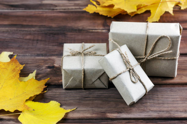 istock gift boxes among autumn leaves on a wooden surface 1179635134