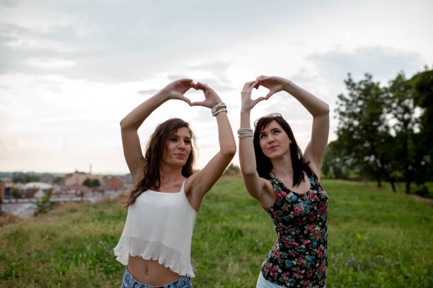 istock two girls having fun in the park, 1179636057