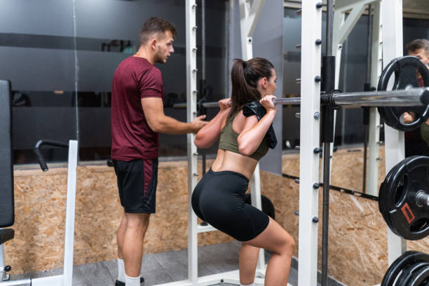 istock Female Athlete Doing Squats With Weights In Gym 1179636235