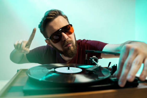 istock Retro DJ man playing music on record player 1179637764