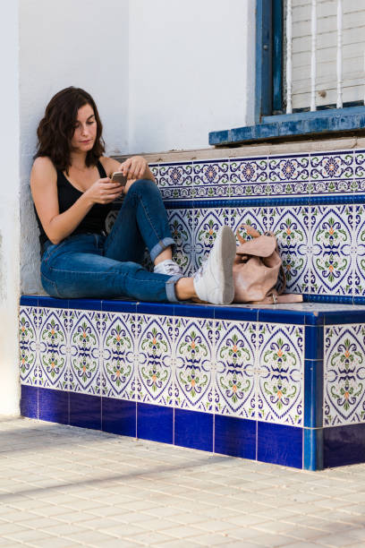 istock Young woman is using her smartphone on the street 1179637841